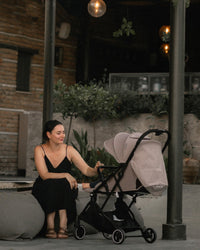 A woman looking at her baby inside the Kinderkraft Stroller INDY2