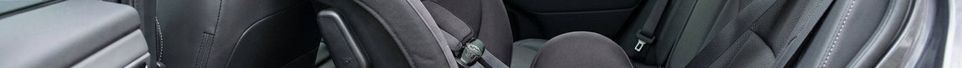 Rear- facing toddler car seat installed in a vehicle’s rear seat.