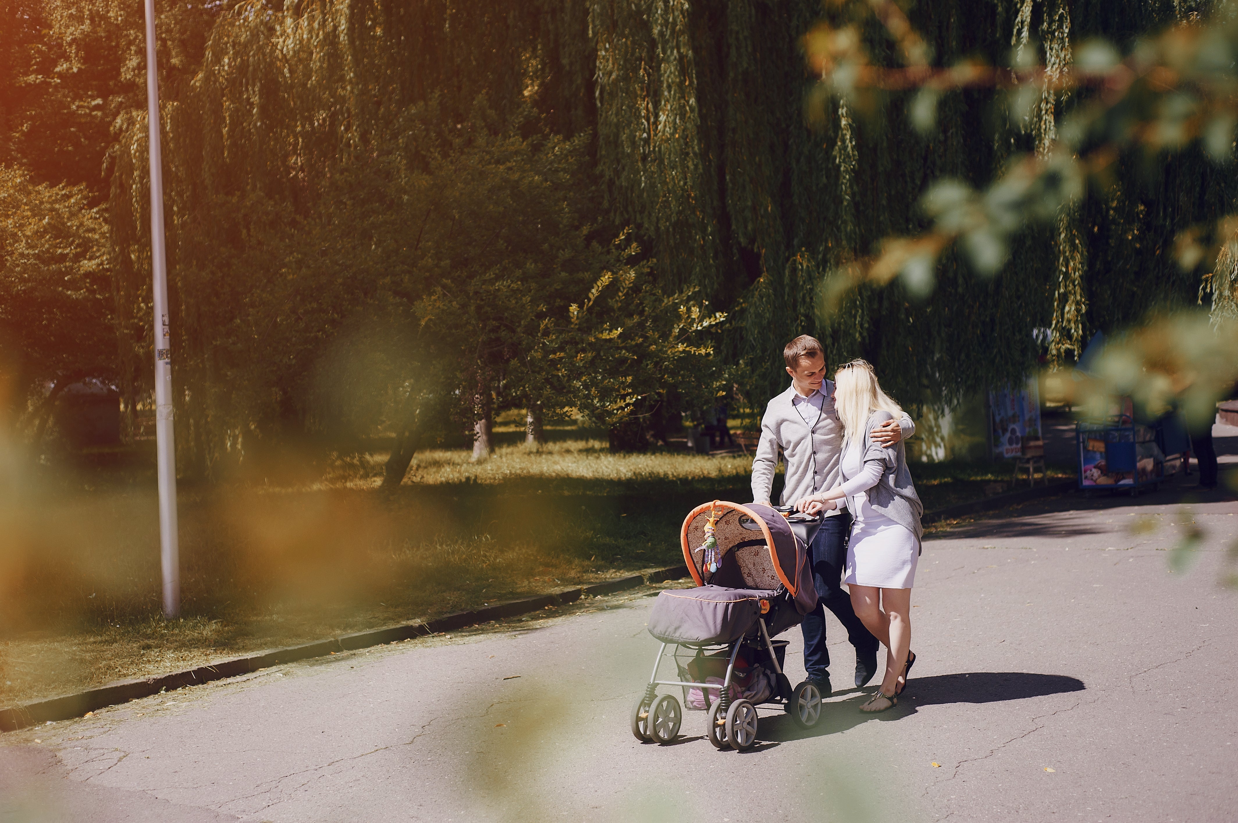 Parent using a modern stroller on a European city street.