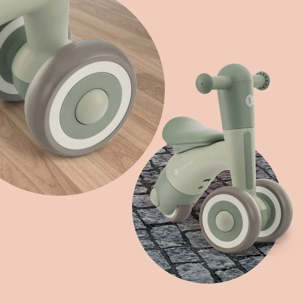 Close-up view of the Kinderkraft Balance Bike MINIBI's wheel on wooden floor.