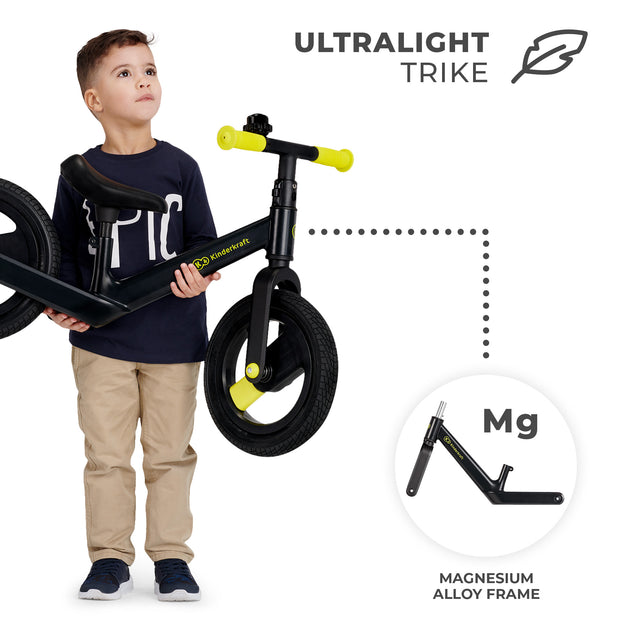 Young boy holding a black Kinderkraft Balance Bike GOSWIFT with ultralight magnesium frame.