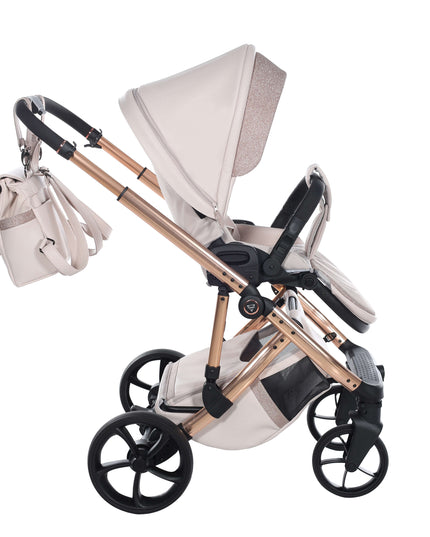 Junama TERMO GLITTER ECO stroller in beige with gold frame, side view showcasing spacious seat and matching bag.