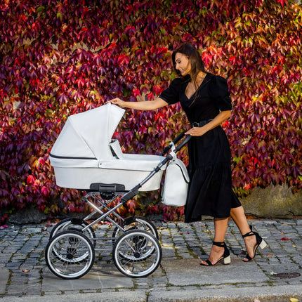 Elegant woman with a Kunert Romantic stroller in Ash Eco Leather against autumn leaves