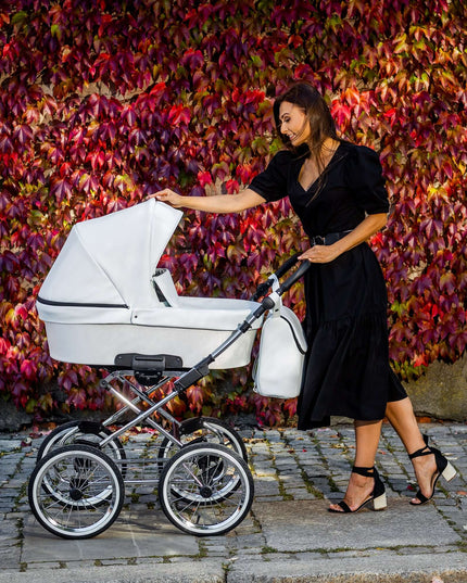 Elegant woman with a Kunert Romantic stroller in Ash Eco Leather against autumn leaves