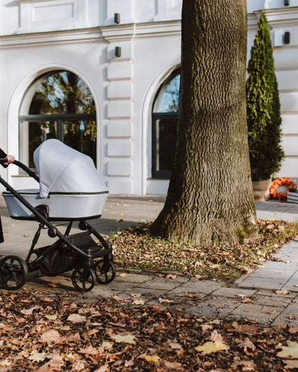 Woman pushing Kunert ARIZO Stroller outside building.