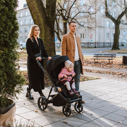 Family with Kunert ARIZO Stroller on a sunny autumn day.