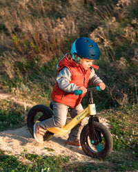 A young boy riding his Kinderkraft Balance Bike GOSWIFT