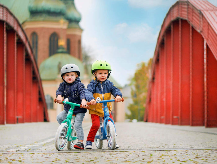 2 Young boys riding the Kinderkraft Balance Bike RAPID 