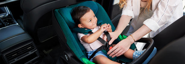 Mother setting up baby Inside the Kinderkraft Car Seat I-Care