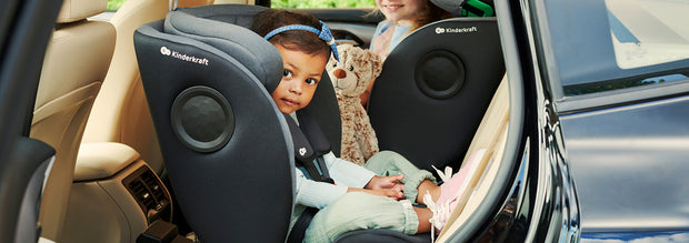 A small girl in a car sitting inside the Kinderkraft Car Seat XRIDER