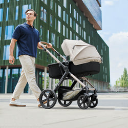 A parent pushing the Kinderkraft MOOV 2 Stroller