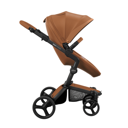 Side view of the Mima XARI MAX stroller, highlighting the camel seat and Pink pad on a durable black chassis.