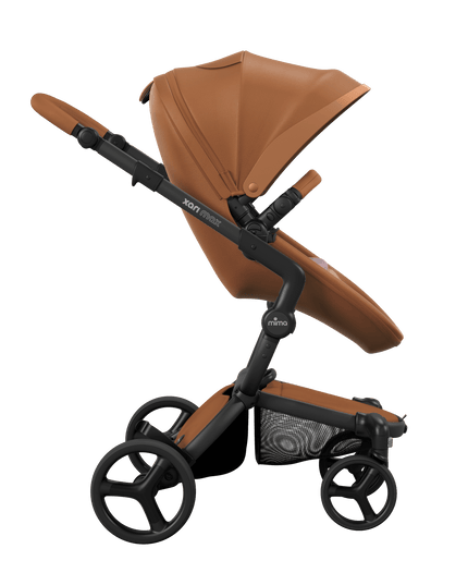 Side view of the Mima XARI MAX stroller, highlighting the camel seat and Pink pad on a durable black chassis.