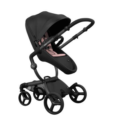 Stylish Mima XARI MAX stroller in black with a pink pad, showcasing a reversible black chassis.