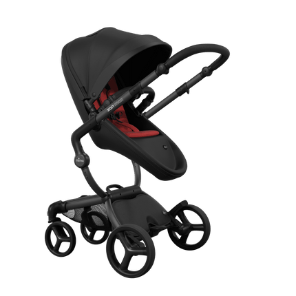 Stylish Mima XARI MAX stroller in black with a red pad, showcasing a reversible black chassis.