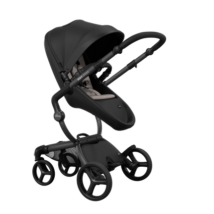 Stylish Mima XARI MAX stroller in black with a sandy beige pad, showcasing a reversible black chassis.