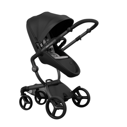 Stylish Mima XARI MAX stroller in black with a white pad, showcasing a reversible black chassis.