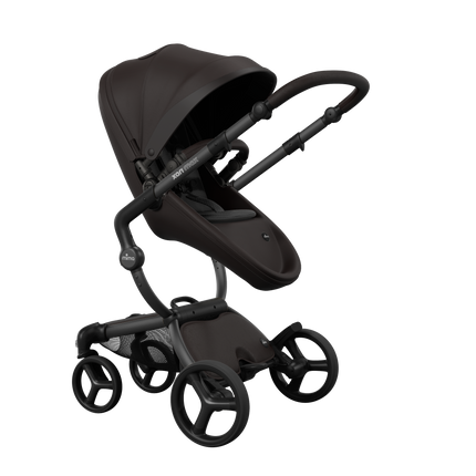 Stylish Mima XARI MAX stroller in chocolate brown with a black pad, showcasing a reversible champagne chassis.