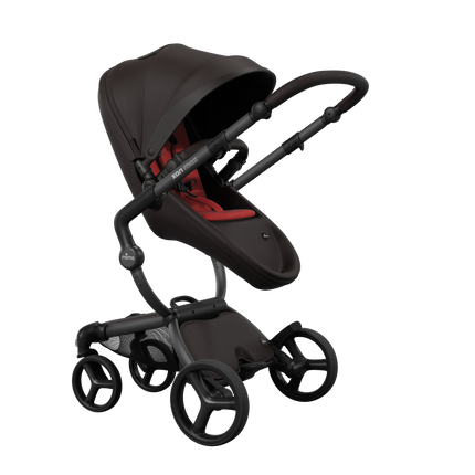 Stylish Mima XARI MAX stroller in chocolate brown with a red pad, showcasing a reversible champagne chassis.