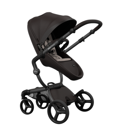 Stylish Mima XARI MAX stroller in chocolate brown with a sandy beige pad, showcasing a reversible champagne chassis.