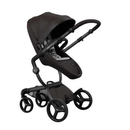 Stylish Mima XARI MAX stroller in chocolate brown with a white pad, showcasing a reversible champagne chassis.