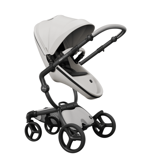 Mima XARI MAX stroller with champagne chassis, snow white seat, and black pad, facing mother.