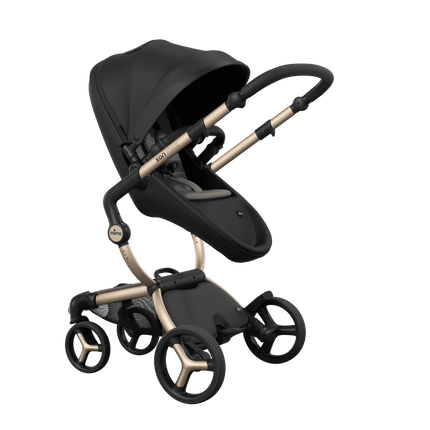 Mima XARI MAX stroller with a black seat and ash brown pad on a champagne chassis, featuring a sleek design.