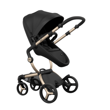 Stylish Mima XARI MAX stroller in black with a black pad, showcasing a reversible champagne chassis.