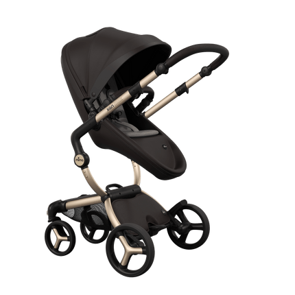 Stylish Mima XARI MAX stroller in chocolate brown with a ash brown pad, showcasing a reversible champagne chassis.