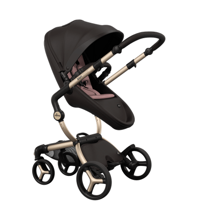 Stylish Mima XARI MAX stroller in chocolate brown with a pink pad, showcasing a reversible champagne chassis.