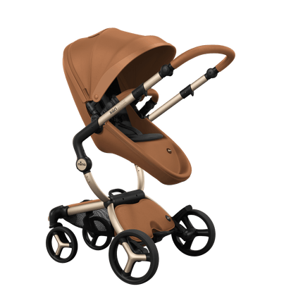 Stylish Mima XARI MAX stroller in camel with a black pad, showcasing a reversible champagne chassis.