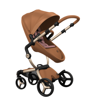 Stylish Mima XARI MAX stroller in camel with a pink pad, showcasing a reversible champagne chassis.