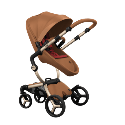 Stylish Mima XARI MAX stroller in camel with a red pad, showcasing a reversible champagne chassis.