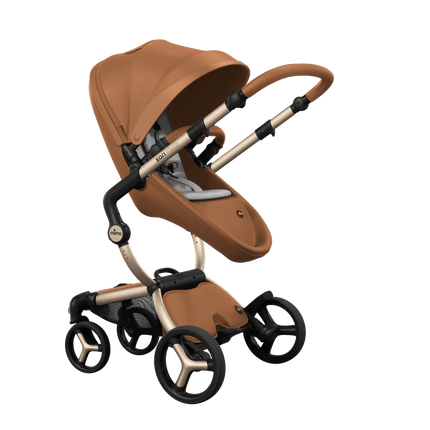 Stylish Mima XARI MAX stroller in camel with a white pad, showcasing a reversible champagne chassis.