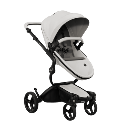 Mima XARI MAX stroller with black chassis, snow white seat, and brown pad, side view.