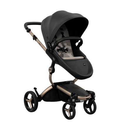 Mima XARI MAX stroller with a black seat and sandy beige pad on a champagne chassis, featuring a sleek design.