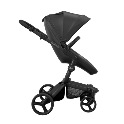 Side view of the Mima XARI MAX stroller, highlighting the black seat and ash ash brown pad on a durable black chassis.