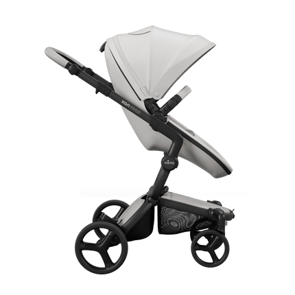 Side view of Mima XARI MAX stroller with black chassis, white seat, and ash brown pad.