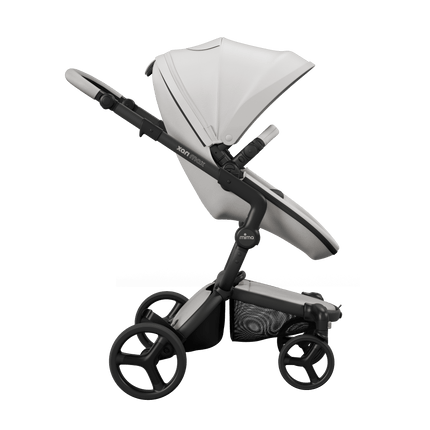 Mima XARI MAX stroller with black chassis, white seat, and black pad, side view.