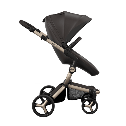 Side view of the Mima XARI MAX stroller, highlighting the chocolate brown seat and ash brown pad on a durable champagne chassis.