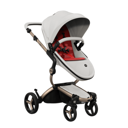 Mima XARI MAX stroller featuring champagne chassis, snow white seat, and vibrant red pad, perfect for stylish outings.