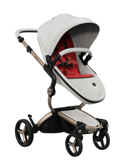 Mima XARI MAX stroller featuring champagne chassis, snow white seat, and vibrant red pad, perfect for stylish outings.