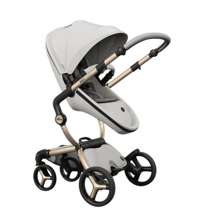 Mima XARI MAX stroller with champagne chassis, snow white seat, and ash brown pad, facing mother for bonding.