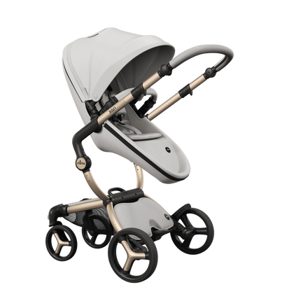 Mother-facing Mima XARI MAX stroller with champagne chassis, snow white seat, and white pad, chic and comfortable.