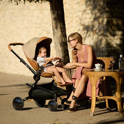 Mima Creo Stroller Mocha at a cafe, mom and baby enjoying the moment.