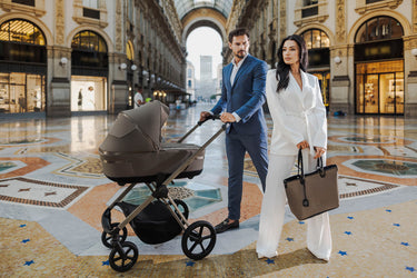 Espiro stroller with a couple in elegant attire, set in a stylish urban location.