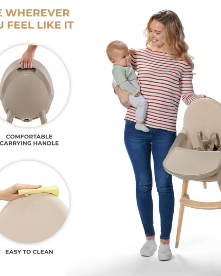 Mother holding baby with a beige Kinderkraft FINI 2 High Chair showing carry handle