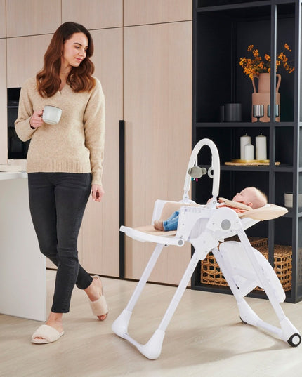 A baby sleeping in the Kinderkraft High Chair TUMMIE 2