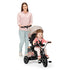 Kinderkraft Tricycle Aston with a mom pushing her child, showcasing its comfort and usability for outdoor fun.