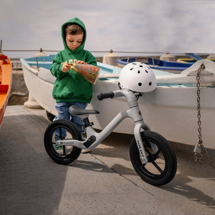 A toddler with the Kinderkraft XPLOIT Balance Bike